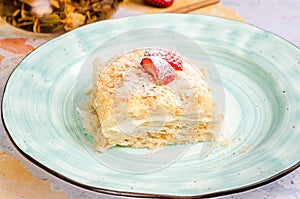 Homemade cake with vanilla custard served with fresh summer strawberries. Delicious strawberry piece of cake Napoleon