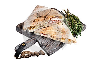 Homemade Calzone closed pizza with ham and cheese on wooden board. Isolated on white background, top view.