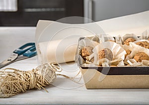 Homemade candies in eco-friendly packaging on the kitchen table. Preparation of an individual order. Small business