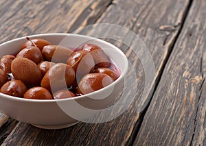 Homemade canned plums in a white bowl