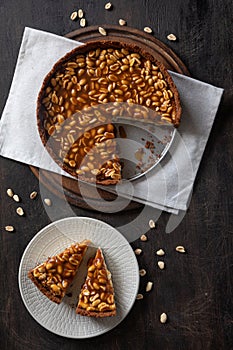 Homemade caramel-peanut cheesecake on a dark background. Morning delicious bakery cake