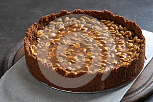 Homemade caramel-peanut cheesecake on a dark background. Morning delicious bakery cake