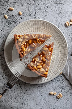 Homemade caramel-peanut cheesecake on a light background. Morning delicious bakery cake