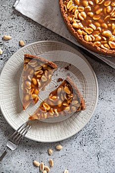 Homemade caramel-peanut cheesecake on a light background. Morning delicious bakery cake