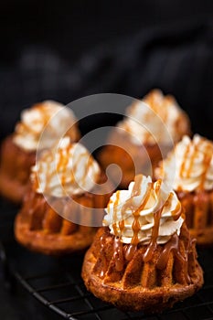 Homemade carrot cupcakes with caramel sauce and cream cheese