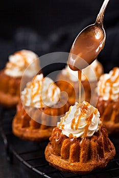 Homemade carrot cupcakes with caramel sauce and cream cheese