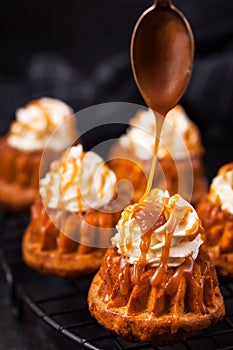 Homemade carrot cupcakes with caramel sauce and cream cheese