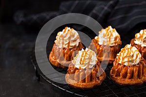 Homemade carrot cupcakes with caramel sauce and cream cheese