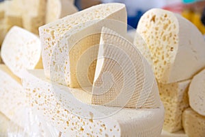 Homemade Caucasian cheese or Bryndza cut in slices at local market