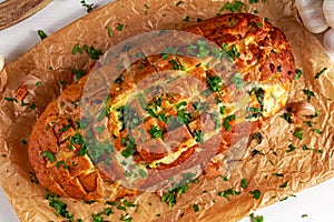 Homemade Cheese Garlic Pull Apart Bread with herbs on crumpled paper