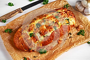 Homemade Cheese Garlic Pull Apart Bread with herbs on crumpled paper