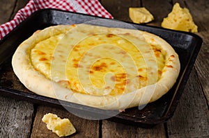 Homemade cheese pizza, Heorgian food - Hachapuri on wooden background. Selective focus