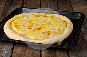 Homemade cheese pizza, Heorgian food - Hachapuri on wooden background. Selective focus