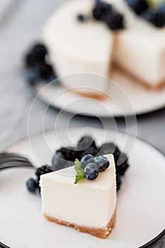 Homemade cheesecake with fresh berries. a piece of cheesecake with a blackberry in the foreground