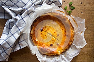 Homemade cheesecake, just out of the oven, on a wooden background