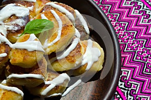 Homemade cheesecakes on a ceramic plate against the background of a vishivanka