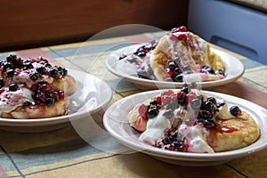 Homemade cheesecakes with sour cream and red and black currant s