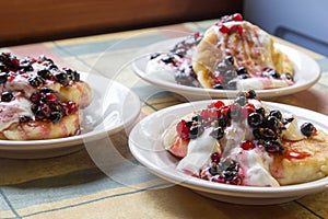 Homemade cheesecakes with sour cream and red and black currant s