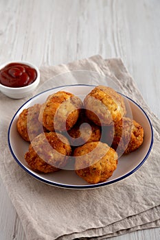 Homemade Cheesy Chicken Nuggets with Ketchup, side view. Copy space