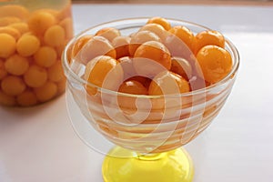 Homemade cherry fruit compote in glass jar. Preserved cherries in syrup in glass bowl on white background