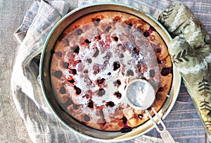 Homemade Cherry pie on round serving board.