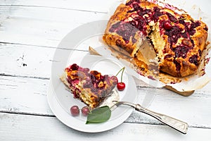 Homemade cherry pie on white rustic wood background