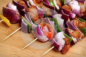 Homemade Chicken and Bacon Skewers Kebabs with Peppers Onions and Herb Marinate on wooden background