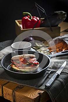 Homemade chicken burger on cast-iron frying pan