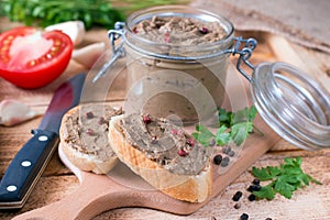 Homemade chicken liver pate on baguette adn with tomatoes photo