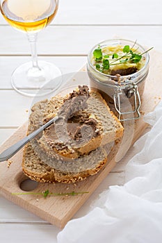 Homemade chicken liver pate on bread on white rustic background. Healthy eating concept. Selective focus