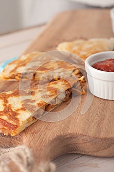 Homemade chicken mexican quesadilla on wooden