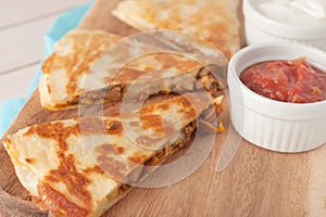 Homemade chicken mexican quesadilla on wooden photo