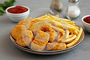 Homemade Chicken Nuggets and French Fries with Ketchup on gray background, side view. Close-up