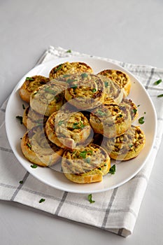 Homemade Chicken Pesto Pinwheels on a Plate, side view