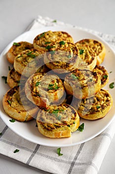 Homemade Chicken Pesto Pinwheels on a Plate, side view