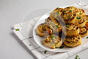 Homemade Chicken Pesto Pinwheels on a Plate, side view. Copy space