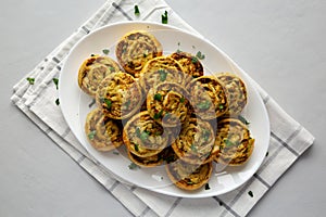 Homemade Chicken Pesto Pinwheels on a Plate, top view. Flat lay, overhead, from above