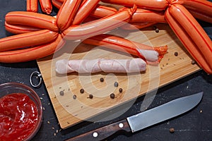 Homemade chicken sausages in polyamide casing on a cutting board