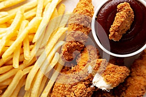 Homemade Chicken Tenders with French Fries and BBQ Sauce, top view. Flat lay, overhead, from above. Close-up