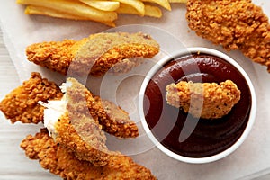 Homemade Chicken Tenders with French Fries and BBQ Sauce, top view. Flat lay, overhead, from above. Close-up