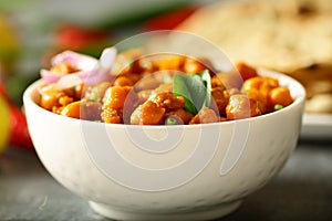 Homemade Chickpea curry served with roti. Indian cuisine.