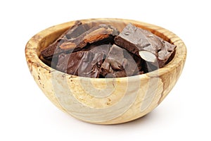 Homemade chocolate with almonds in wood bowl