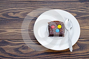 Homemade chocolate brownie with colorful button-shaped chocolate