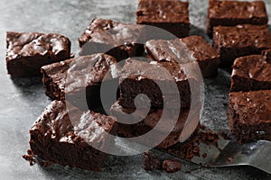 Homemade Chocolate Brownies made from chocolate 80 percentages with chocolate chip 98 percentage inside on dark tone. Use monk