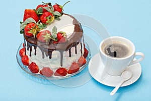 Homemade chocolate cake decorated with fresh strawberries on glass plate and cup of coffee with saucer