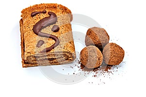 Homemade chocolate candy and roll, isolate on white background. Roulade and candy drenched with chocolate. Delicious chocolate