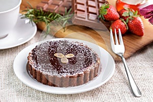 homemade chocolate cheese pie cake with chocolate bar and strawberry
