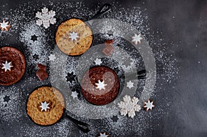 Homemade chocolate chip cookie and brownie decorated with snowflake candy on iron skillet