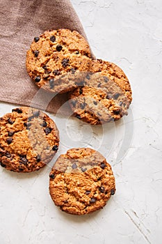 Homemade chocolate chip cookies on a white stone background. Top