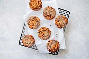 Homemade chocolate chips cookies on a wire rack on a white stone